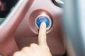 Finger press a car ignition button or START engine inside modern electric automobile. Keyless, change, strategy, vision, Royalty Free Stock Photo