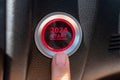 Finger press a car ignition button with 2024 START text inside automobile. New Year New You, forecast, resolution, motivation,