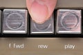 Finger pressed a rewind button of a vintage tape recorder macro Royalty Free Stock Photo