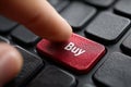 Finger presses buy button on computer keyboard Royalty Free Stock Photo