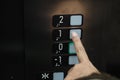 Finger presses elevator button to go to first floor Royalty Free Stock Photo