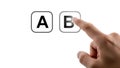 Finger pressing button B next to button A, A B Testing, choice, decision, selection, comparison, concept Royalty Free Stock Photo