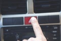 Finger pressing emergency button on car dashboard Royalty Free Stock Photo
