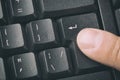Finger pressing the ENTER button of keyboard. Close up and toned image. Royalty Free Stock Photo