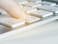 Finger is pressing enter key of a aluminum white computer keyboard Royalty Free Stock Photo