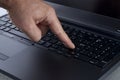 Finger Pressing the Enter Key on a Laptop Keyboard Royalty Free Stock Photo