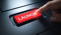 Finger Pressing a Glowing Red Launch Button Royalty Free Stock Photo