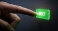 Finger Pressing Illuminated Green Next Button hand Royalty Free Stock Photo
