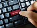 A finger pressing a keyboard key with the word `New Normal` printed on it. Back to office  during Covid-19 pandemic Royalty Free Stock Photo