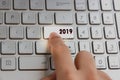 Finger pressing keyboard key written 2019 new year on laptop Royalty Free Stock Photo