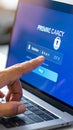 Finger pressing login button on laptop screen displaying privacy and security information with a padlock icon. Royalty Free Stock Photo
