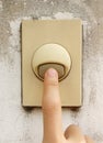 Finger pressing on old door bell switch Royalty Free Stock Photo