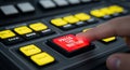 Finger pressing red button on control panel with multiple buttons and controls in closeup view Royalty Free Stock Photo