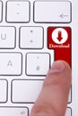 Finger pressing the red download button Royalty Free Stock Photo