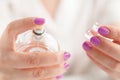 Finger pressing the sprayer on perfume bottle Royalty Free Stock Photo