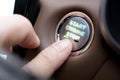 Finger Pressing Start Engine Stop Button in Car Interior Representing Control, Technology, Safety and Modern Driving Royalty Free Stock Photo