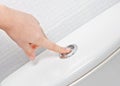 Finger pushing button and flushing toilet Royalty Free Stock Photo