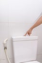 Finger pushing button and flushing toilet Royalty Free Stock Photo
