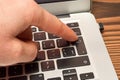 Finger pushing enter button on laptop keyboard Royalty Free Stock Photo