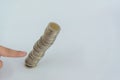 Finger pushing a pile of coins, column of coins falls , business Royalty Free Stock Photo