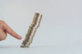 Finger pushing a pile of coins, column of coins falls , business Royalty Free Stock Photo