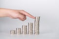 Finger pushing a pile of coins, column of coins falls , business Royalty Free Stock Photo