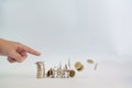 Finger pushing a pile of coins, column of coins falls , business Royalty Free Stock Photo