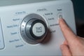 Finger pushing power button on electric dryer Royalty Free Stock Photo