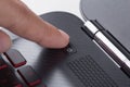Finger pushing power button on laptop keyboard