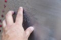 Finger reading braille tactile on public park message board