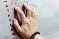 Finger reading braille tactile on public park message board