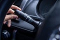 Finger is spinning a wiper control button on the car steering wheel, Close-up and Soft-focus view Royalty Free Stock Photo