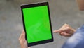 Finger swiping green tablet screen closeup. Businesswoman using chroma key pad Royalty Free Stock Photo