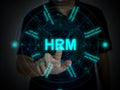 A finger tapping or activating HRM function on a futuristic virtual screen with eight components of HRM. Human Resource Management