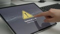 Finger tapping tablet screen displaying technical issue warning Royalty Free Stock Photo