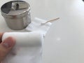 Finger tip hold roll gauze on blur swab and gauze jar in medical concept