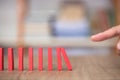 Finger to knock down a row of dominoes Royalty Free Stock Photo