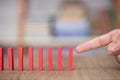 Finger to knock down a row of dominoes Royalty Free Stock Photo