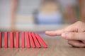 Finger to knock down a row of dominoes Royalty Free Stock Photo