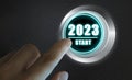 Finger about to press a car ignition button with the text 2023 start. Year two thousand and twenty three concept Royalty Free Stock Photo