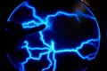 Finger touch electric plasma ball on a dark background. Static electricity model Royalty Free Stock Photo