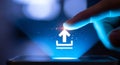 Finger Tapping Upload Icon on Blue Screen with Sparkles, Technology Concept Royalty Free Stock Photo
