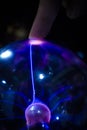 Finger touching an energy ball with a lightning light ray crossing a sphere Royalty Free Stock Photo