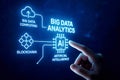Finger touching screen displaying Big Data Analytics AI Blockchain and Cloud Computing icons artificial intelligence Royalty Free Stock Photo