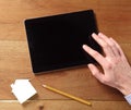 Finger Touching the Screen of an Off Tablet Device Royalty Free Stock Photo