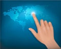 Finger touching world map on a touch screen.