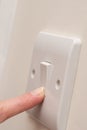 Finger Turning ON lIght Switch on Wall COPY SPACE Royalty Free Stock Photo