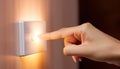 A finger turning off a light switch. Concept of energy conservation. Royalty Free Stock Photo
