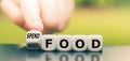 Finger turns a dice and changes the expression `waste food` to `spend food. Royalty Free Stock Photo