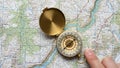 Finger is visible pointing at the compass. This scene suggests a Royalty Free Stock Photo